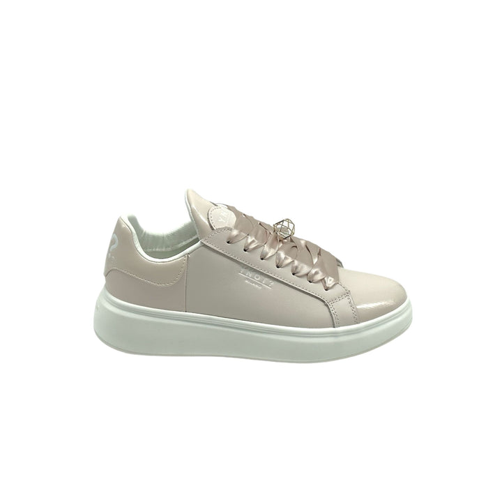 Sneakers in pelle nude liscia con lacci ed accessorio geometrico sui lacci